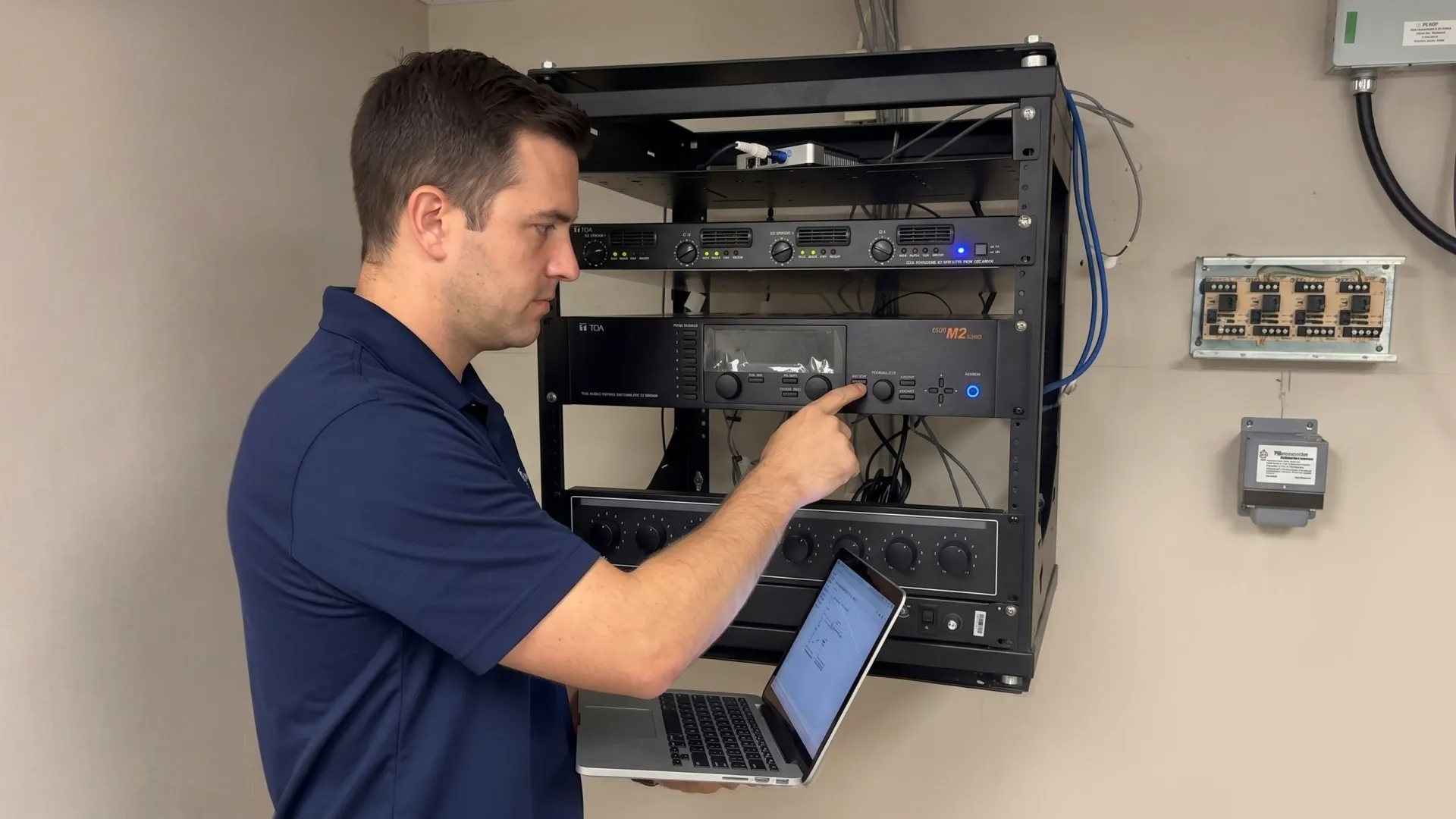 Field Tech technician troubleshooting an AV rack on-site