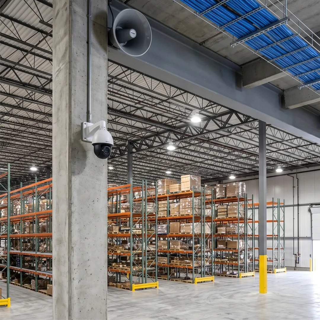 Warehouse with overhead paging speaker and CCTV camera